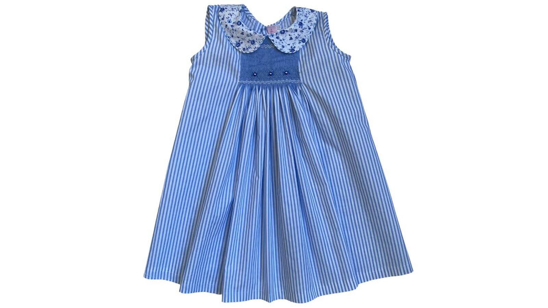 Smocked blue floral stripe dress by Emily Lacey showcasing artisanal craftsmanship and timeless childhood charm.