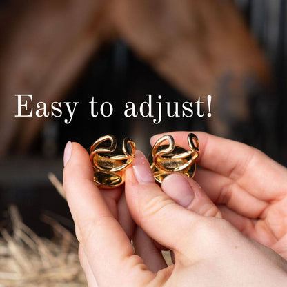 Hands holding adjustable Black and Tan Horse Houndstooth Needlepoint Rings, showcasing their flexibility for easy fitting.