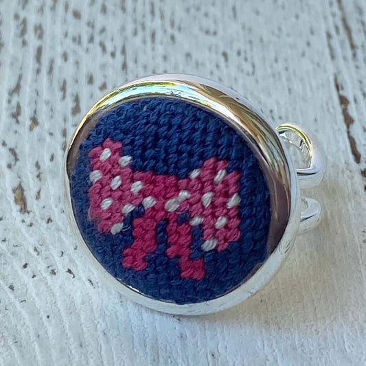 Close-up of a Pink Bow Needlepoint Ring on a silver adjustable band, showcasing colorful needlepoint detail.