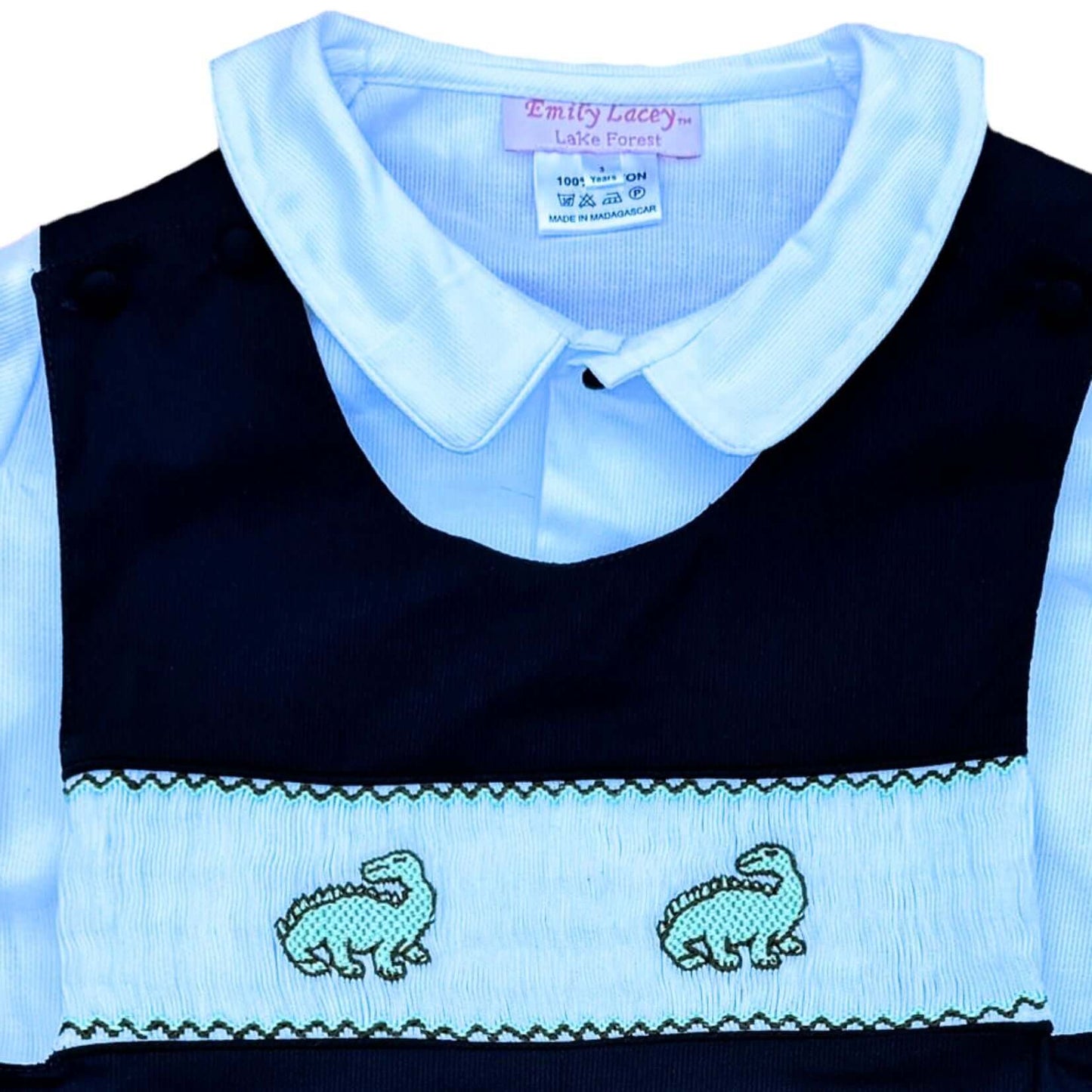 Adorable Smocked Dinosaur John John with covered buttons and navy trim, perfect for preschool photos, birthdays, holidays, or daily wear.