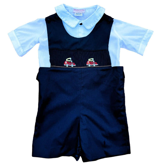 Smocked Navy Firetruck John John outfit with hand-smocked firetrucks, covered buttons, and navy trim, perfect for special occasions and daily wear.