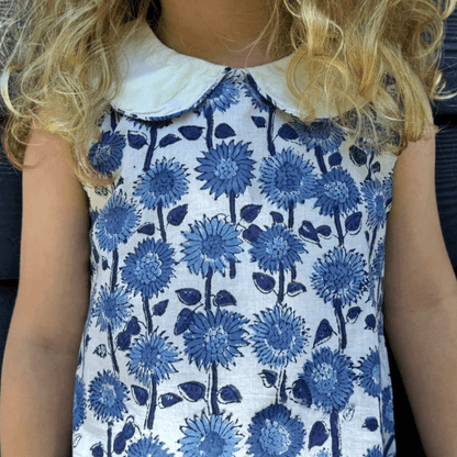 Close-up of the Blue Sunflower dress with blue and white Provence floral print, Peter Pan collar, and sleeveless Aline design