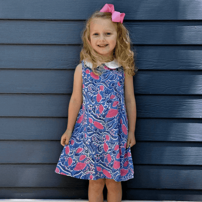 Little girl in a Sky and Pink Floral Dress with Peter Pan collar and pink bow, ready for back-to-school.