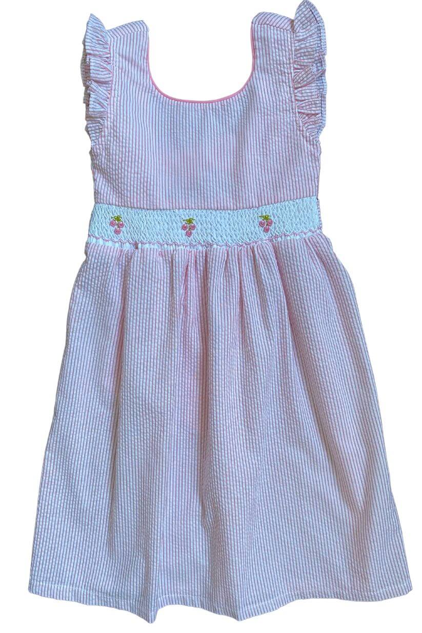 Smocked pink cherry dress with ruffle sleeves and embroidered cherries on the bodice.