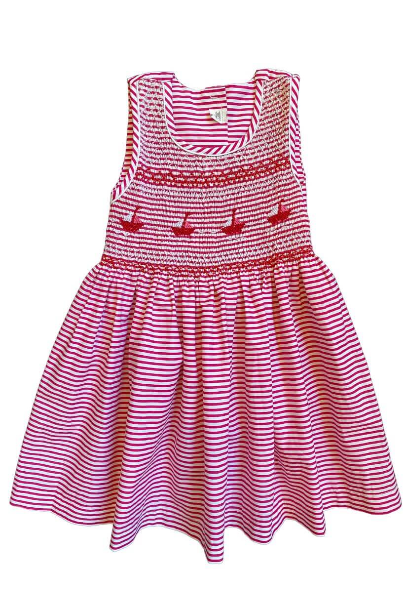 Smocked red striped boat dress for girls, featuring charming sailboat embroidery, perfect for seaside adventures.