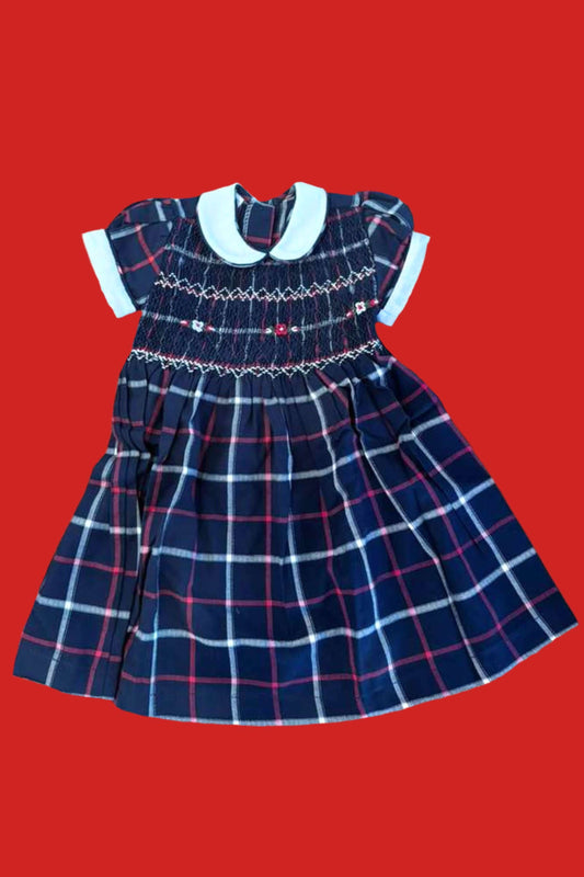 Sample Smocked Navy Plaid Dress featuring hand-smocked floral design on a classic plaid fabric.