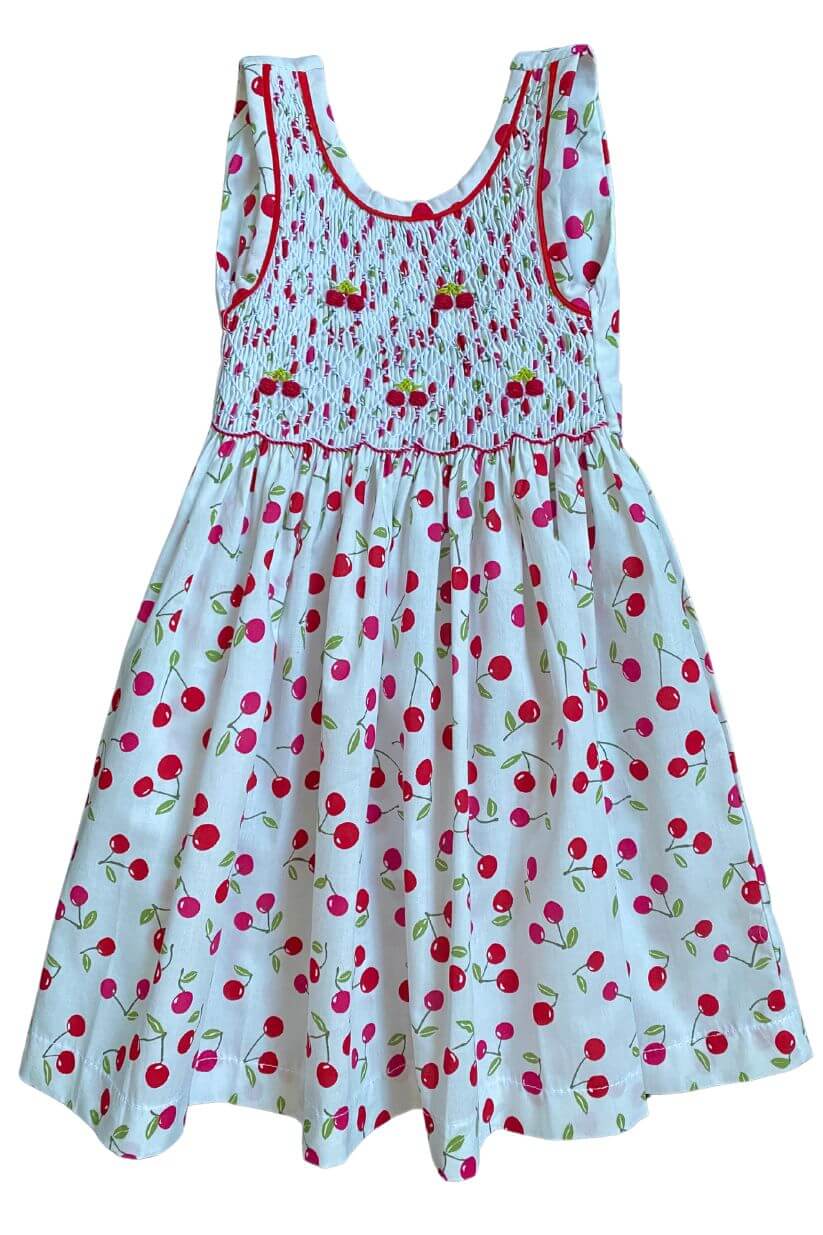 Hand-smocked cherry dress featuring delicate floral embroidery, perfect for warm spring days.