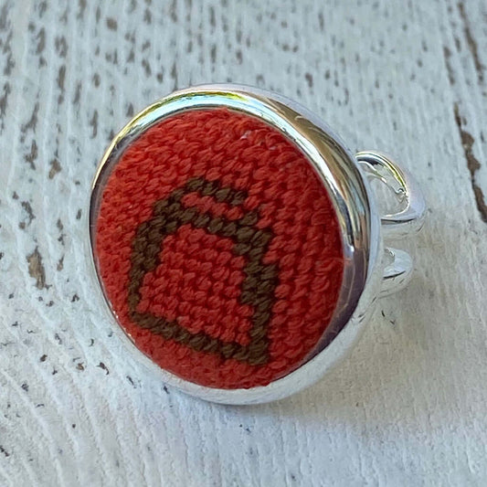 Orange and brown needlepoint stirrup silver ring, perfect equestrian gift, adjustable, versatile as scarf ring or charm.