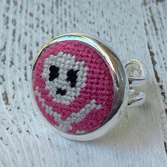 Pink Jolly Roger needlepoint ring with silver adjustable band, perfect as a unique gift or charm accessory.