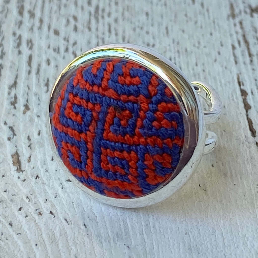 Handcrafted orange and blue Greek key needlepoint ring, adjustable size, perfect as a unique gift or scarf ring.