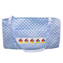 Smocked Sailboat Cotton Duffel Bag made of quilted blue cotton with colorful sailboat design, perfect baby shower gift for new parents.