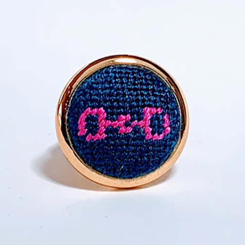 Navy and pink snaffle bit needlepoint ring with adjustable arms, perfect equestrian gift and versatile accessory.