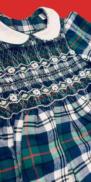 Sample Smocked Holiday Plaid Dress featuring a hand-smocked floral pattern and collar detail.