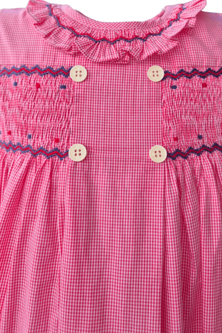 Close-up of a hand-smocked red check ruffle dress featuring delicate embroidery and double buttons.