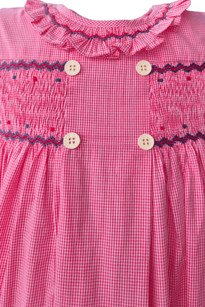 Close-up of a hand-smocked red check ruffle dress featuring delicate embroidery and double buttons.