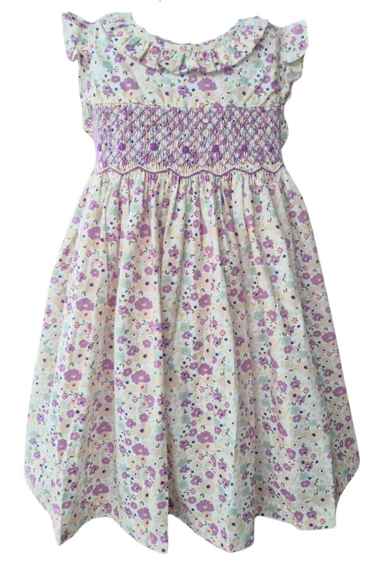 Hand-smocked purple floral dress with delicate embroidery, perfect for warm spring days.